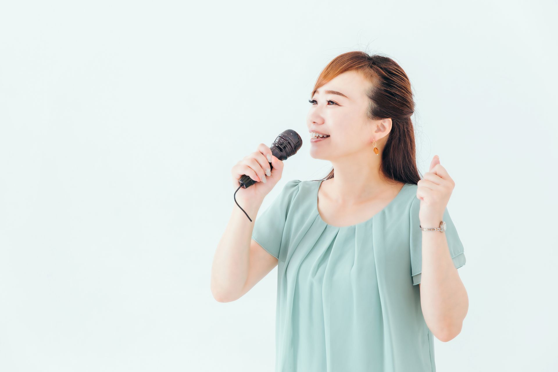 A woman is singing into a microphone.