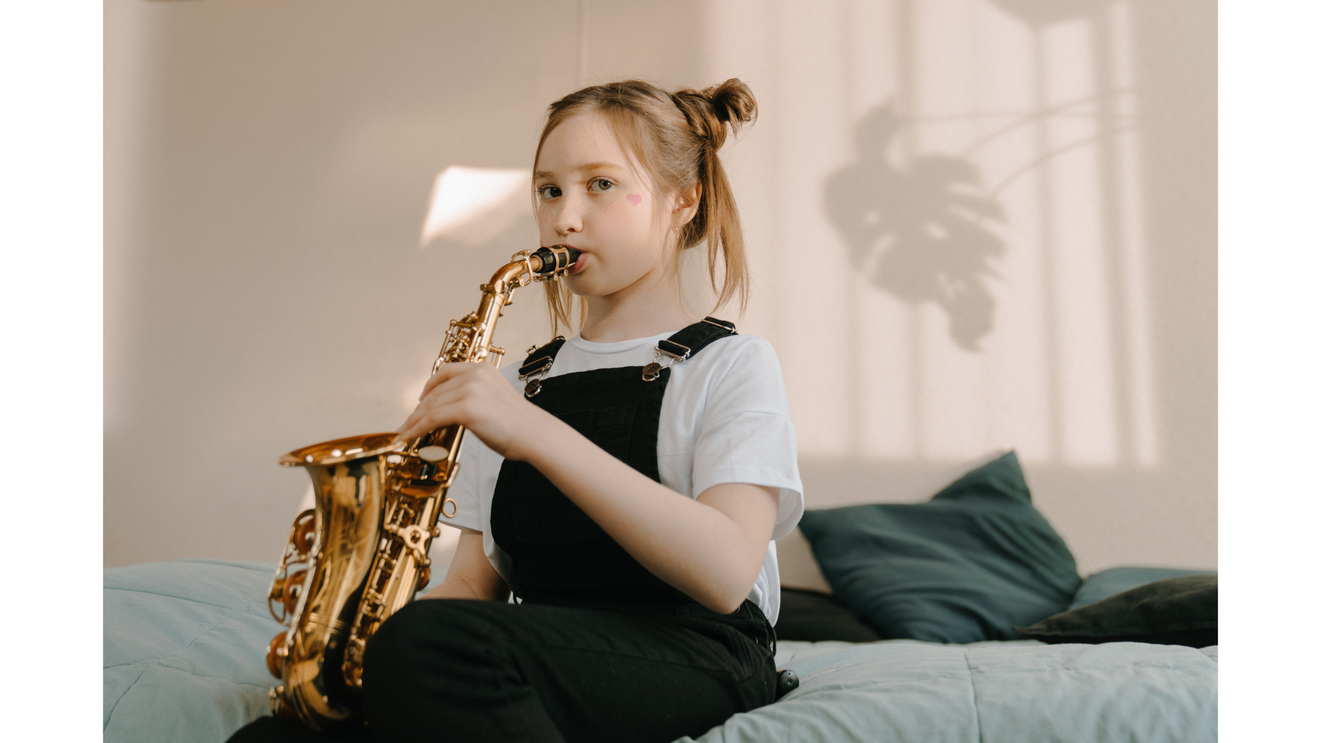 a saxophone is sitting on a white surface .
